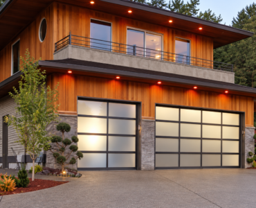 Aluminium framed glass garage doors on a residential facade