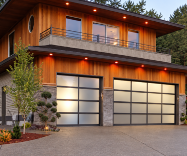 Aluminium framed glass garage doors on a residential facade