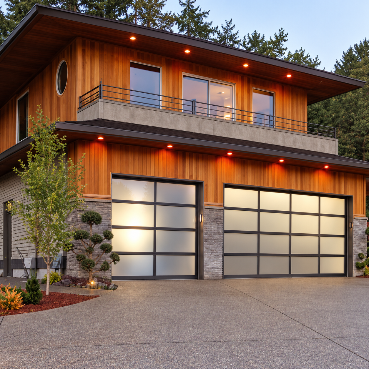 Aluminium framed glass garage doors on a residential facade